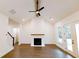 Spacious living room with a fireplace, vaulted ceiling, ceiling fan, and hardwood floors at 6525 Rhett Run, Cumming, GA 30028