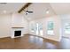 Bright and airy living room featuring hardwood floors and a fireplace, with outdoor access at 6525 Rhett Run, Cumming, GA 30028