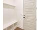 Functional mudroom featuring white board and batten, shelving and seating at 6525 Rhett Run, Cumming, GA 30028