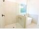 Open glass shower featuring bench seating, and tiled walls and flooring at 6525 Rhett Run, Cumming, GA 30028