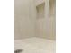 Close up of tiled shower with drain and shower accessories at 6525 Rhett Run, Cumming, GA 30028