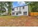 View of the home's back elevation shows a patio with sliding glass doors and a partially fenced yard at 1841 Surrey Hill Cir, Lawrenceville, GA 30044