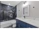 Updated bathroom features shower over tub with decorative tile, vanity with marble counter, and modern fixtures at 1841 Surrey Hill Cir, Lawrenceville, GA 30044