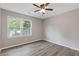 This bedroom offers neutral paint, ceiling fan and light and bright flooring with an exterior window at 1841 Surrey Hill Cir, Lawrenceville, GA 30044