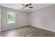 Cozy bedroom with ceiling fan, vinyl plank flooring, and natural light at 1841 Surrey Hill Cir, Lawrenceville, GA 30044