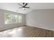 Light-filled bedroom with vaulted ceiling, ceiling fan, and vinyl plank flooring at 1841 Surrey Hill Cir, Lawrenceville, GA 30044