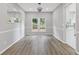 Dining room with hardwood floors, neutral paint, modern light fixture, and lots of windows at 1841 Surrey Hill Cir, Lawrenceville, GA 30044