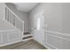 Bright entryway featuring hardwood floors, white trim, staircase, and a front door with glass at 1841 Surrey Hill Cir, Lawrenceville, GA 30044