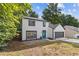 Charming two-story home with a well-maintained front yard, a blue front door, and an attached garage at 1841 Surrey Hill Cir, Lawrenceville, GA 30044