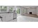 Open kitchen with marble floors, stainless steel appliances, white cabinets, and a sliding glass door at 1841 Surrey Hill Cir, Lawrenceville, GA 30044