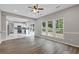 Open-concept living room with kitchen view, ample natural light, and vinyl plank flooring at 1841 Surrey Hill Cir, Lawrenceville, GA 30044