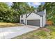 View of the side of a two-story home with an attached garage and a freshly paved driveway at 1841 Surrey Hill Cir, Lawrenceville, GA 30044