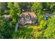 An aerial shot captures a luxurious home with well-kept landscaping, nestled among lush trees, creating a private oasis at 1865 Mason Mill Rd, Decatur, GA 30033