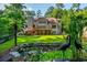Expansive backyard featuring lush greenery, a charming pond, and a spacious deck perfect for outdoor relaxation at 1865 Mason Mill Rd, Decatur, GA 30033