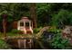 Tranquil backyard oasis with a gazebo, serene pond, and a beautiful waterfall feature amidst lush landscaping at 1865 Mason Mill Rd, Decatur, GA 30033