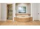 Elegant bathroom with a soaking tub, walk-in shower, and decorative tile work at 1865 Mason Mill Rd, Decatur, GA 30033
