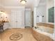 Luxurious bathroom featuring soaking tub, tile floors, and stylish fixtures at 1865 Mason Mill Rd, Decatur, GA 30033