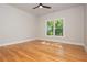 Bedroom with wood floors and a large window allowing an abundance of natural light at 1865 Mason Mill Rd, Decatur, GA 30033