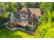 Spacious brick home boasts a wooden deck, multiple windows, and a well-manicured lawn surrounded by mature trees at 1865 Mason Mill Rd, Decatur, GA 30033