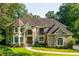 Beautiful brick home with well-manicured lawn and mature trees offering curb appeal and privacy at 1865 Mason Mill Rd, Decatur, GA 30033
