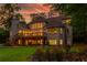 A grand brick house featuring a spacious wooden deck with outdoor access and a lush, landscaped backyard with red flowers at 1865 Mason Mill Rd, Decatur, GA 30033