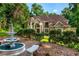 Traditional-style home with a water fountain and landscaped yard, perfect for enjoying the outdoors at 1865 Mason Mill Rd, Decatur, GA 30033