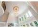 Stunning foyer featuring a soaring ceiling with elegant chandelier and large windows letting in natural light at 1865 Mason Mill Rd, Decatur, GA 30033