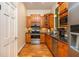 Compact kitchen featuring wooden cabinets, stainless steel appliances, and granite countertops at 1865 Mason Mill Rd, Decatur, GA 30033