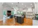 Open kitchen/living space with stainless appliances, island with seating, and a cozy fireplace at 1865 Mason Mill Rd, Decatur, GA 30033