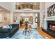 Bright living room featuring a fireplace, large windows, hardwood floors, and elegant decor with an overhead balcony at 1865 Mason Mill Rd, Decatur, GA 30033