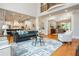 Open-concept living room with soaring ceilings, hardwood floors, and stylish furnishings, adjacent to modern kitchen at 1865 Mason Mill Rd, Decatur, GA 30033