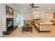 Elegant living room featuring a black marble fireplace, neutral color palette, and chandelier lit dining area at 1865 Mason Mill Rd, Decatur, GA 30033