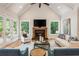 Bright living room with fireplace, vaulted ceilings, hardwood floors, and access to the outdoor deck at 1865 Mason Mill Rd, Decatur, GA 30033