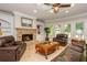 Inviting living room featuring a stone fireplace, built-in shelving, and natural light from large windows at 1865 Mason Mill Rd, Decatur, GA 30033