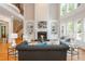 Spacious living room with fireplace, built-in shelving, and large windows providing natural light and a view of the greenery at 1865 Mason Mill Rd, Decatur, GA 30033