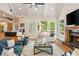 Cozy living room with fireplace, beamed ceilings, French doors to deck, and hardwood floors at 1865 Mason Mill Rd, Decatur, GA 30033