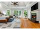 Bright main bedroom features fireplace, hardwood flooring, and multiple windows at 1865 Mason Mill Rd, Decatur, GA 30033