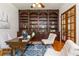 Elegant home office with custom built-ins, hardwood floors, and French doors at 1865 Mason Mill Rd, Decatur, GA 30033