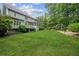 Expansive backyard featuring lush green lawn, mature trees, screened porch, and play area at 4275 Green Summers Dr, Cumming, GA 30028