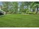 Expansive backyard with lush lawn, swing, mature trees and ample space for recreation at 4275 Green Summers Dr, Cumming, GA 30028