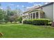 Scenic backyard view showcasing the home's screened porch, mature trees, and greenery at 4275 Green Summers Dr, Cumming, GA 30028