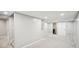 A spacious basement with a door leading to a bathroom, and stairs to the main floor at 4275 Green Summers Dr, Cumming, GA 30028