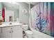 Bathroom with white vanity, toilet, and shower with a colorful unicorn curtain at 4275 Green Summers Dr, Cumming, GA 30028