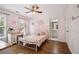 Bedroom featuring hardwood floors, a ceiling fan, a vanity, and light pink paint at 4275 Green Summers Dr, Cumming, GA 30028