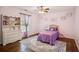 A bedroom featuring hardwood floors, a window, and light purple paint at 4275 Green Summers Dr, Cumming, GA 30028