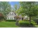 Charming two-story home featuring a welcoming front porch and beautifully landscaped front yard at 4275 Green Summers Dr, Cumming, GA 30028