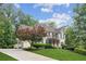 Attractive home showcasing a well-manicured lawn and a long driveway leading to a side-entry garage at 4275 Green Summers Dr, Cumming, GA 30028