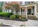 Inviting front porch with stone accents, American flag, and well-maintained landscaping at 4275 Green Summers Dr, Cumming, GA 30028