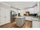 White kitchen featuring stainless steel refrigerator and appliances, granite countertops, and a center island at 4275 Green Summers Dr, Cumming, GA 30028