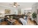 Spacious living room with a large sectional sofa and open access to the dining area and staircase at 4275 Green Summers Dr, Cumming, GA 30028
